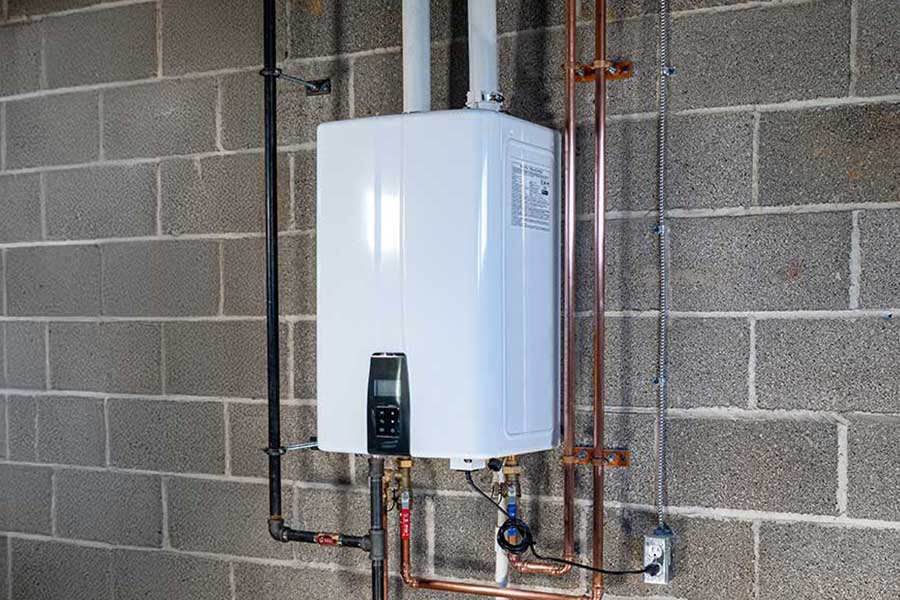 Tankless water heater installed on a concrete wall