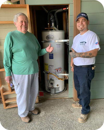 employee and customer smiling in front of a new water heater