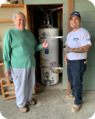 employee and customer smiling in front of a new water heater